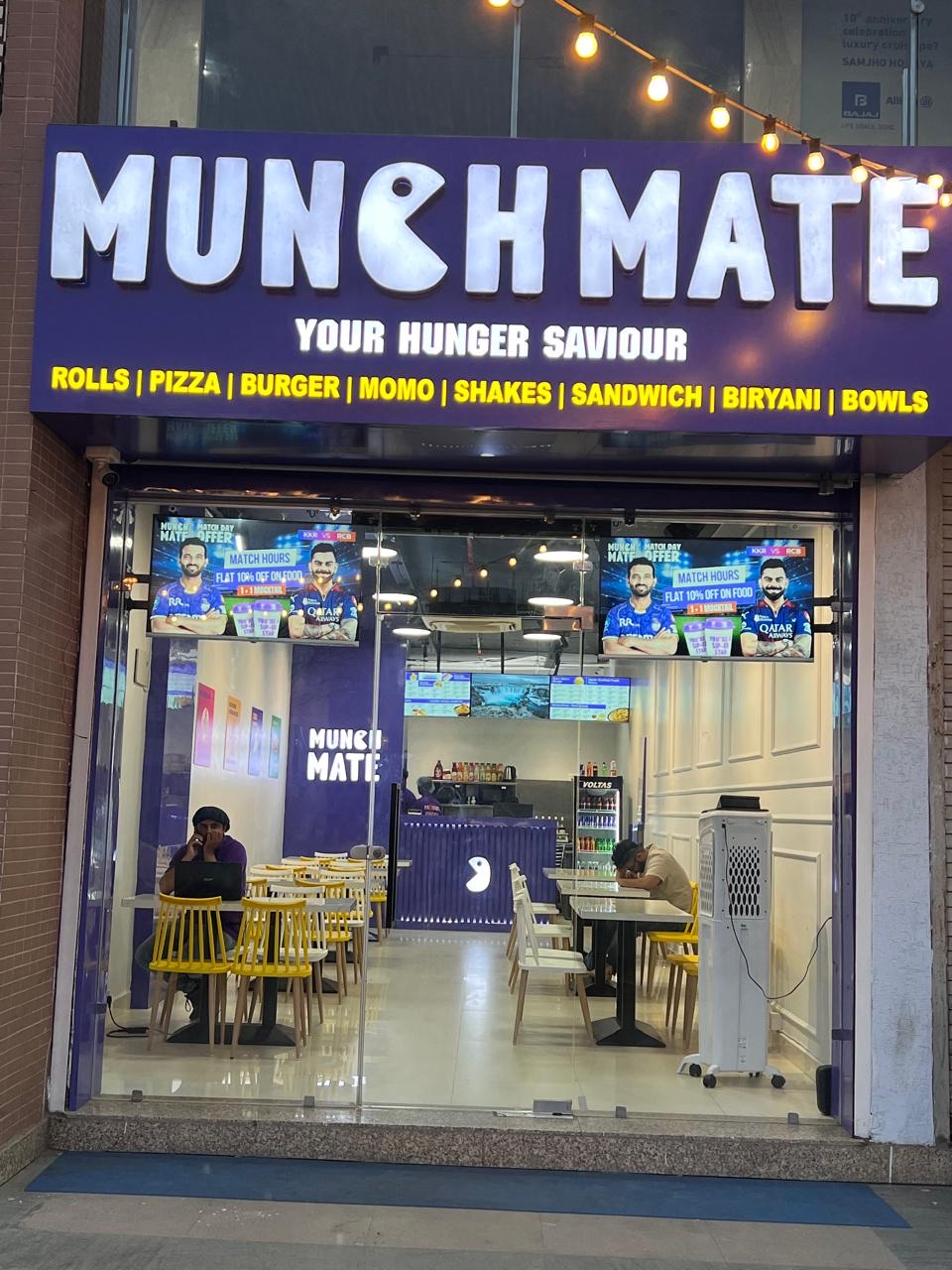 cozy restaurant interior with purple accents, people enjoying food, warm lighting, Bhopal India